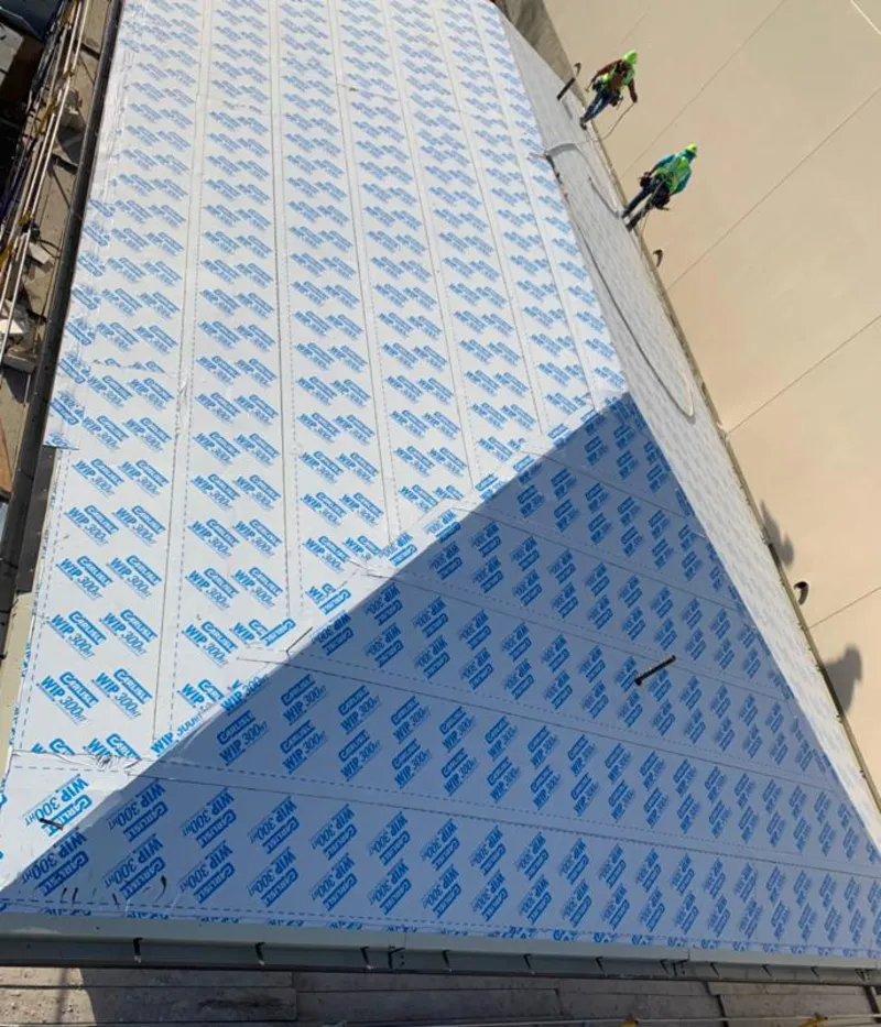 Professional roofers installing underlayment on a metal roof in Crestwood